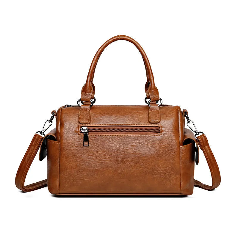Vintage-style large messenger bag in PU leather, showing horizontal square shape and contrast stitching.