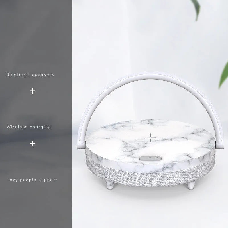 Marble pattern wireless charging LED night light with Bluetooth speaker and integrated mobile phone holder.