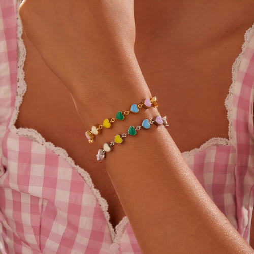 Close-up of a women's love heart-shaped bracelet in stainless steel with 18K gold plating.