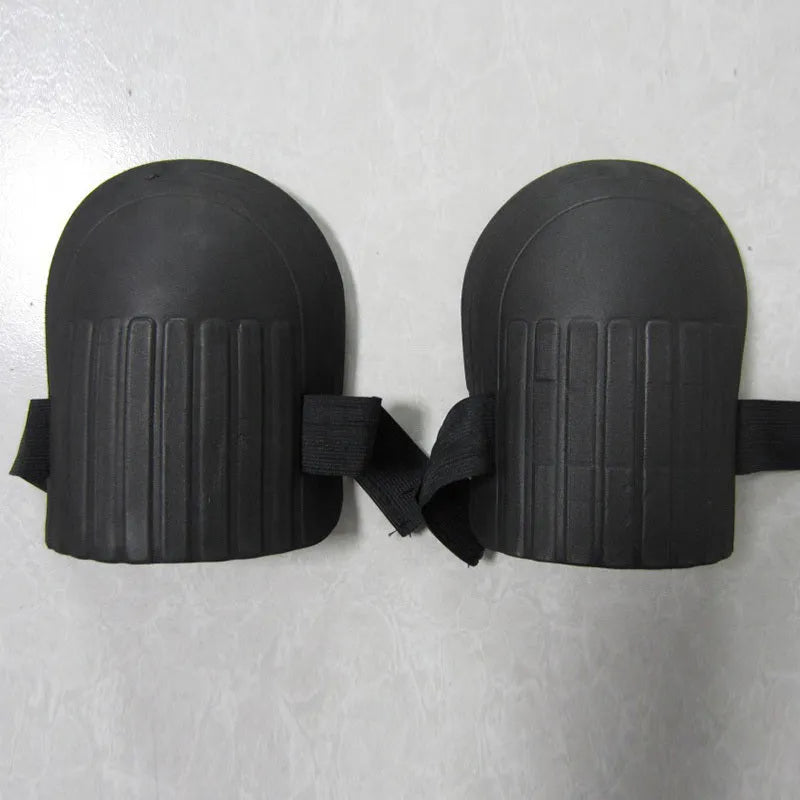 A pair of rectangular EVA foam knee pads in army green colour, shown on a garden soil background.