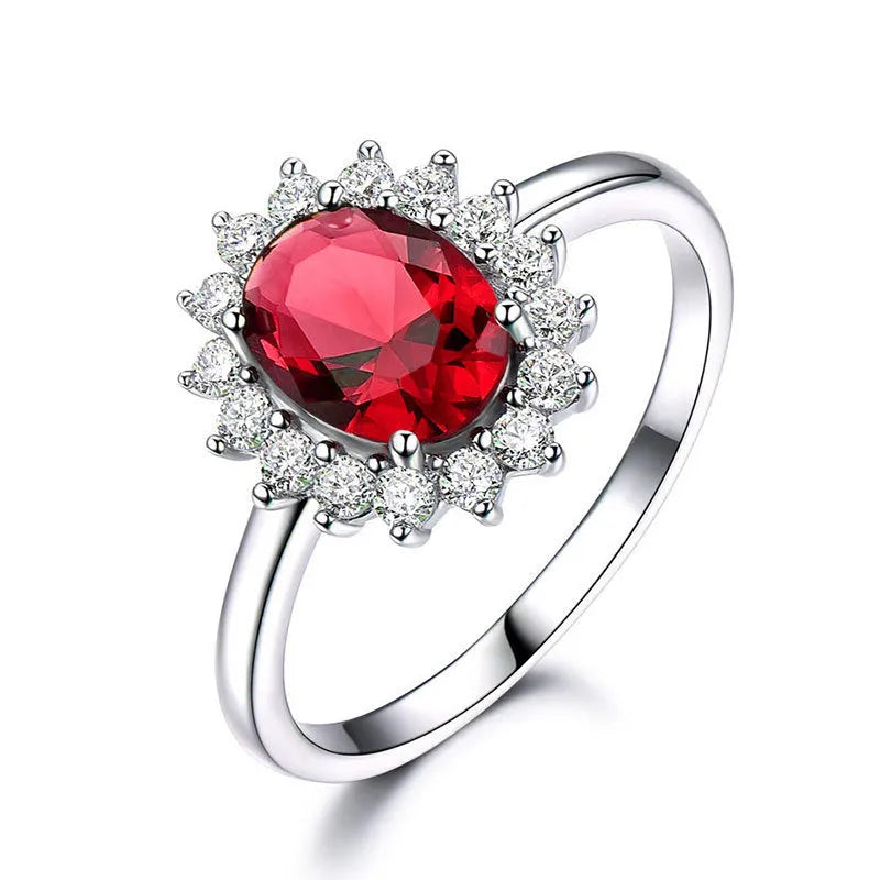 Copper women's ring with floral zirconium design in green, blue, or red on a model's hand.