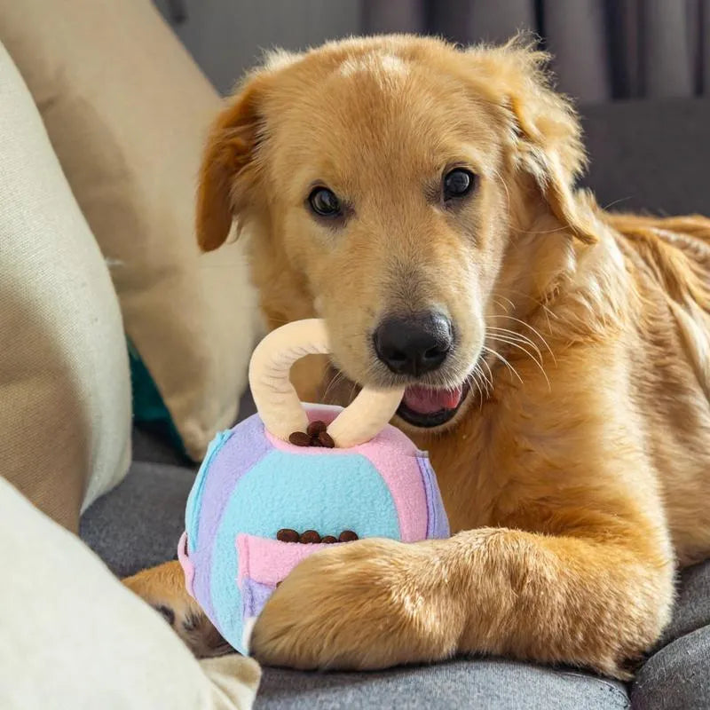 Green or pink polyester plush ball dog toy with treat pockets and a squeaker, shown next to dog treats.