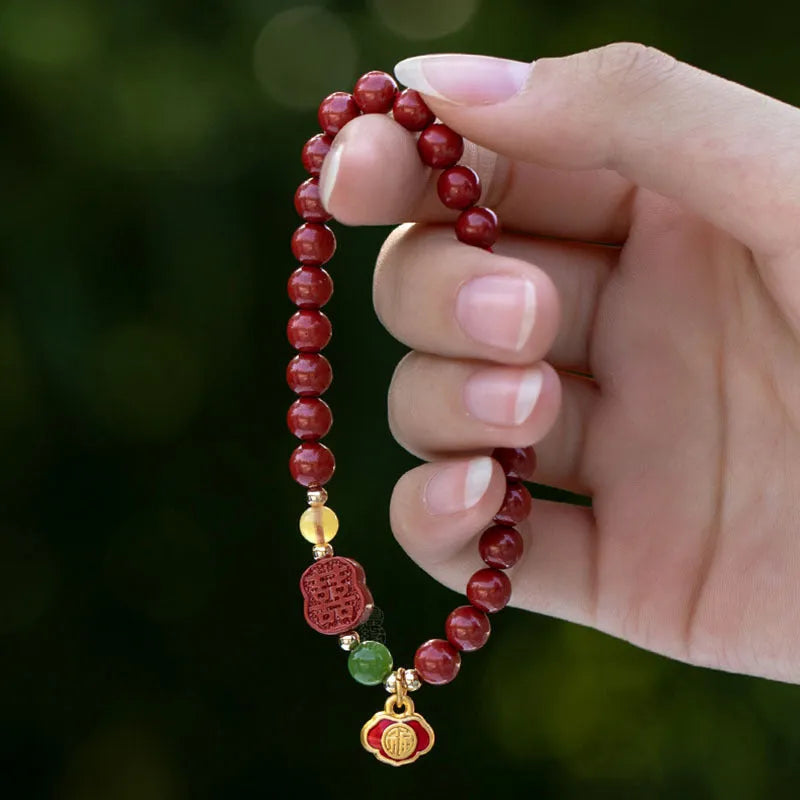 Chinese cinnabar bracelet with emperor sandstone beads and a carved fu character symbol.