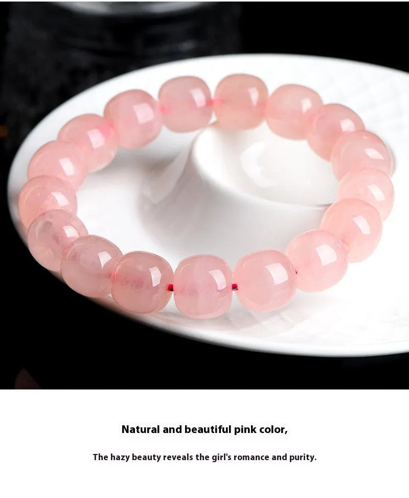 Natural pink crystal barrel bead bracelet with 8x10mm geometric beads on wrist