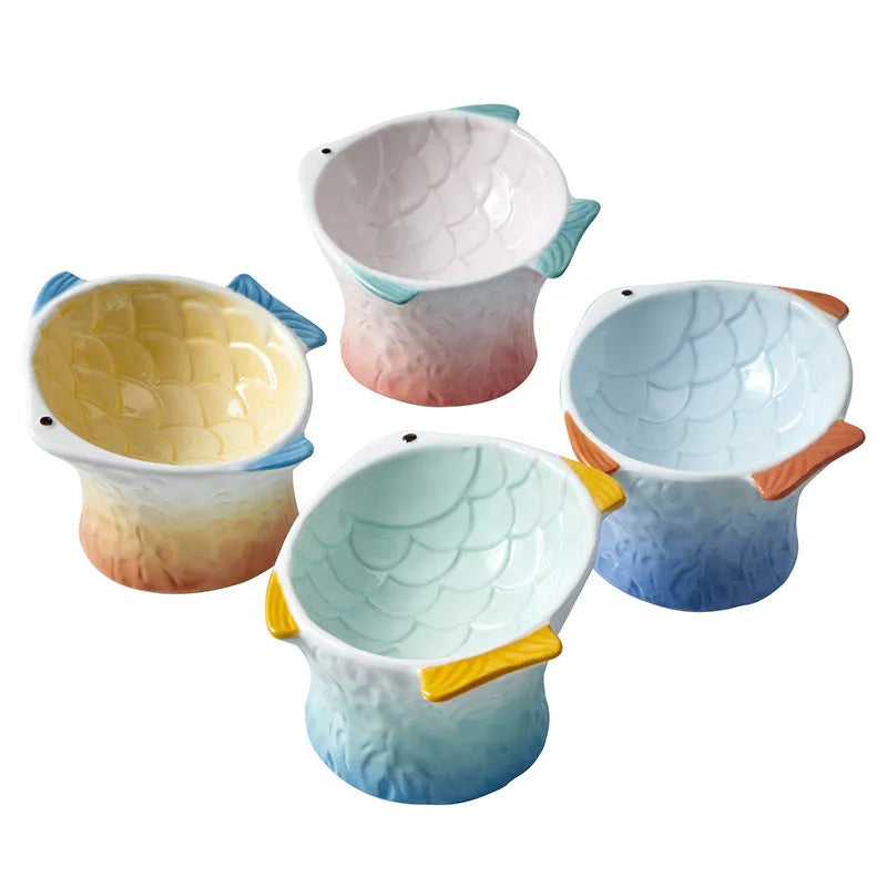 Fish-shaped ceramic cat bowls with 15-degree tilt angle in blue, green, pink, or yellow colours