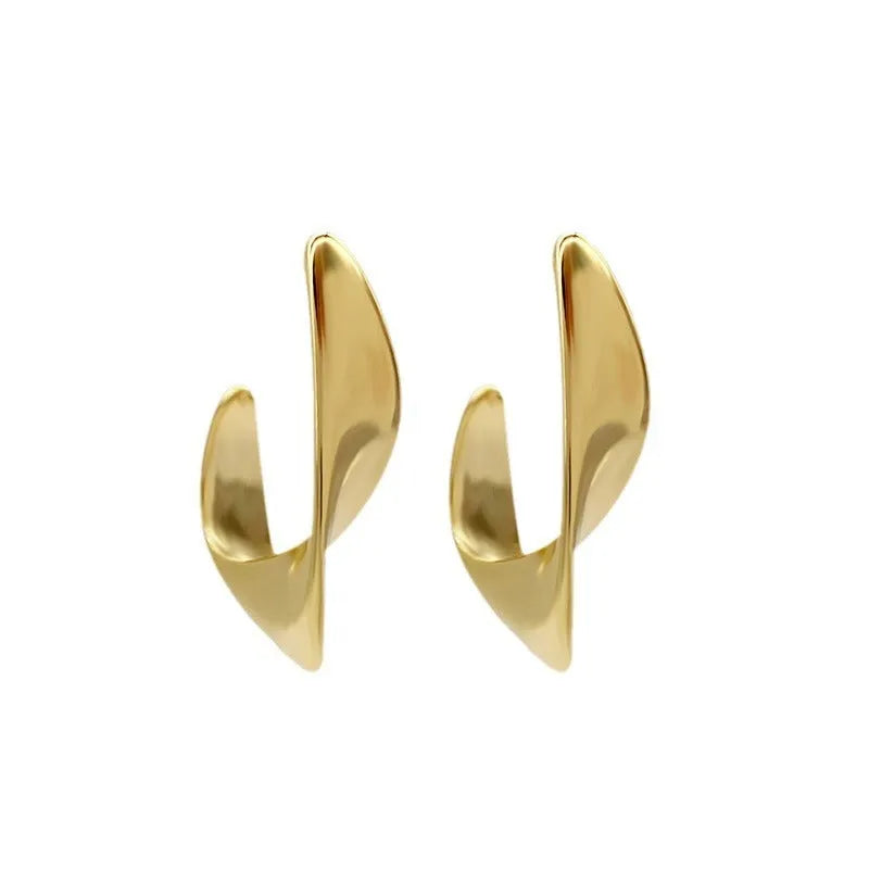 Twisted geometric metal earrings with electroplated gold finish and round design elements