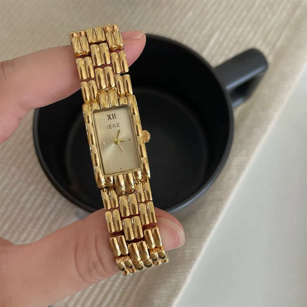 Women's bracelet-style watch with 15mm dial, silver stripe strap, and butterfly clasp