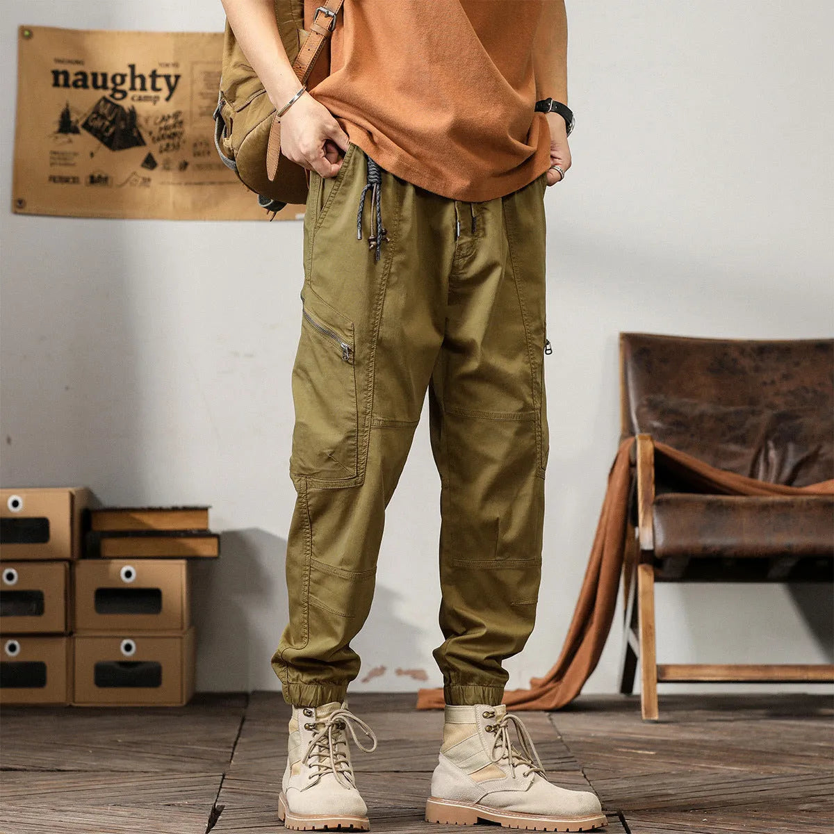 Men's loose khaki cotton harem trousers with tapered leg and ankle banding.