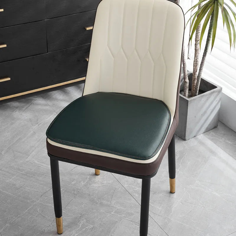 Leather horseshoe-shaped non-slip seat cushion in a solid colour on a chair.