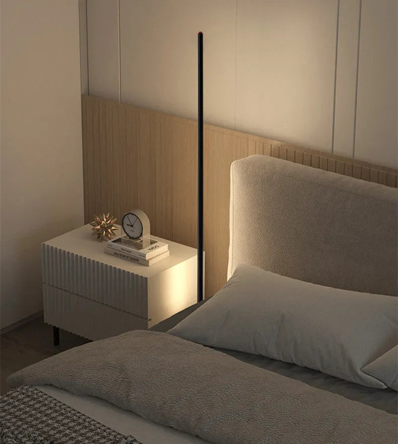A tall, vertical aluminium alloy floor lamp with a modern design on a simple base.