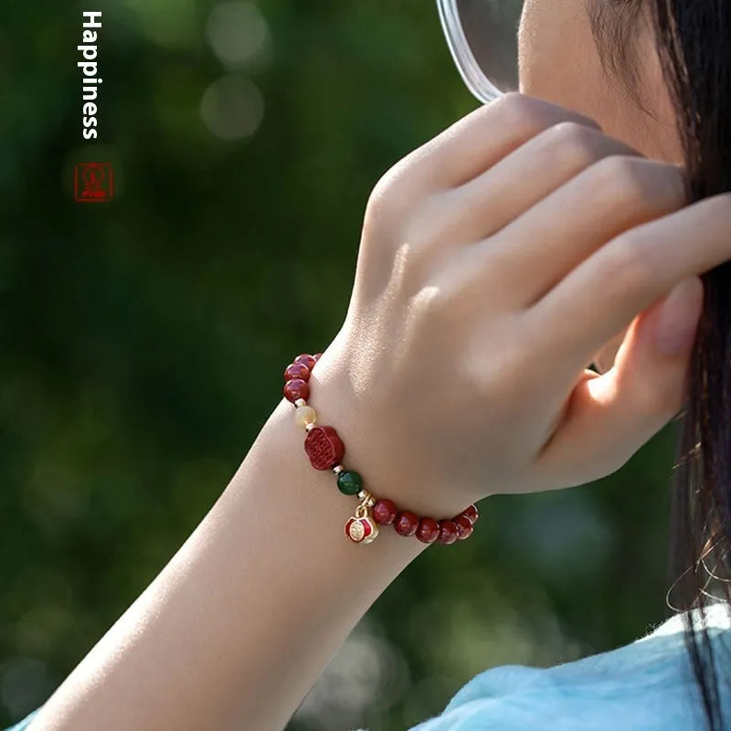 Chinese cinnabar bracelet with emperor sandstone beads and a carved fu character symbol.