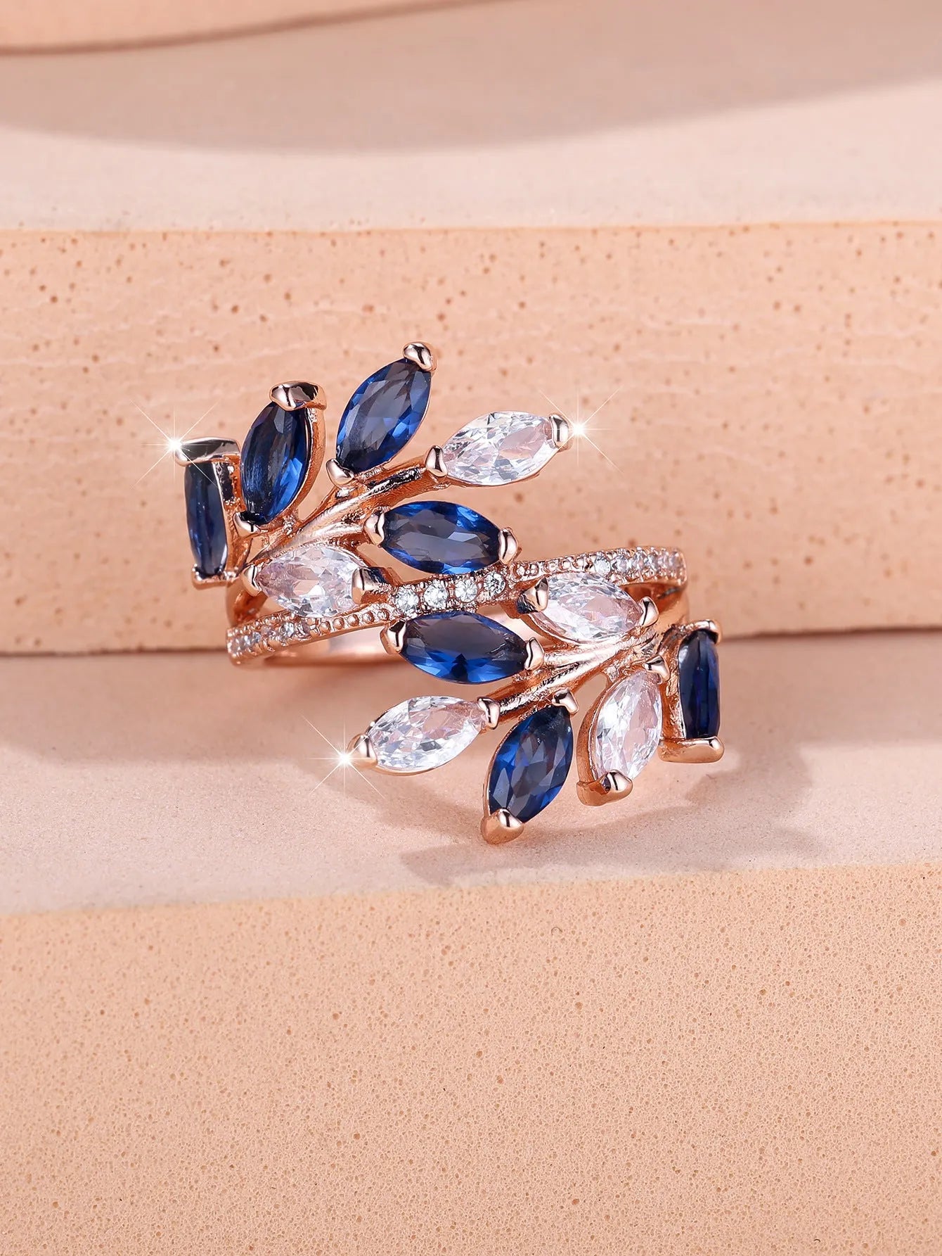 Adjustable horse eye zircon leaf ring in copper on a hand, showing leaf detail and colour options.
