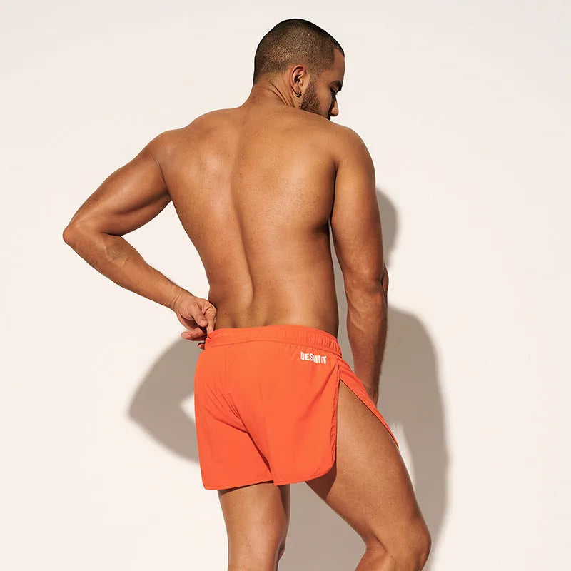 Men's loose beach surfing shorts in quick-dry polyester available in orange, green, and black