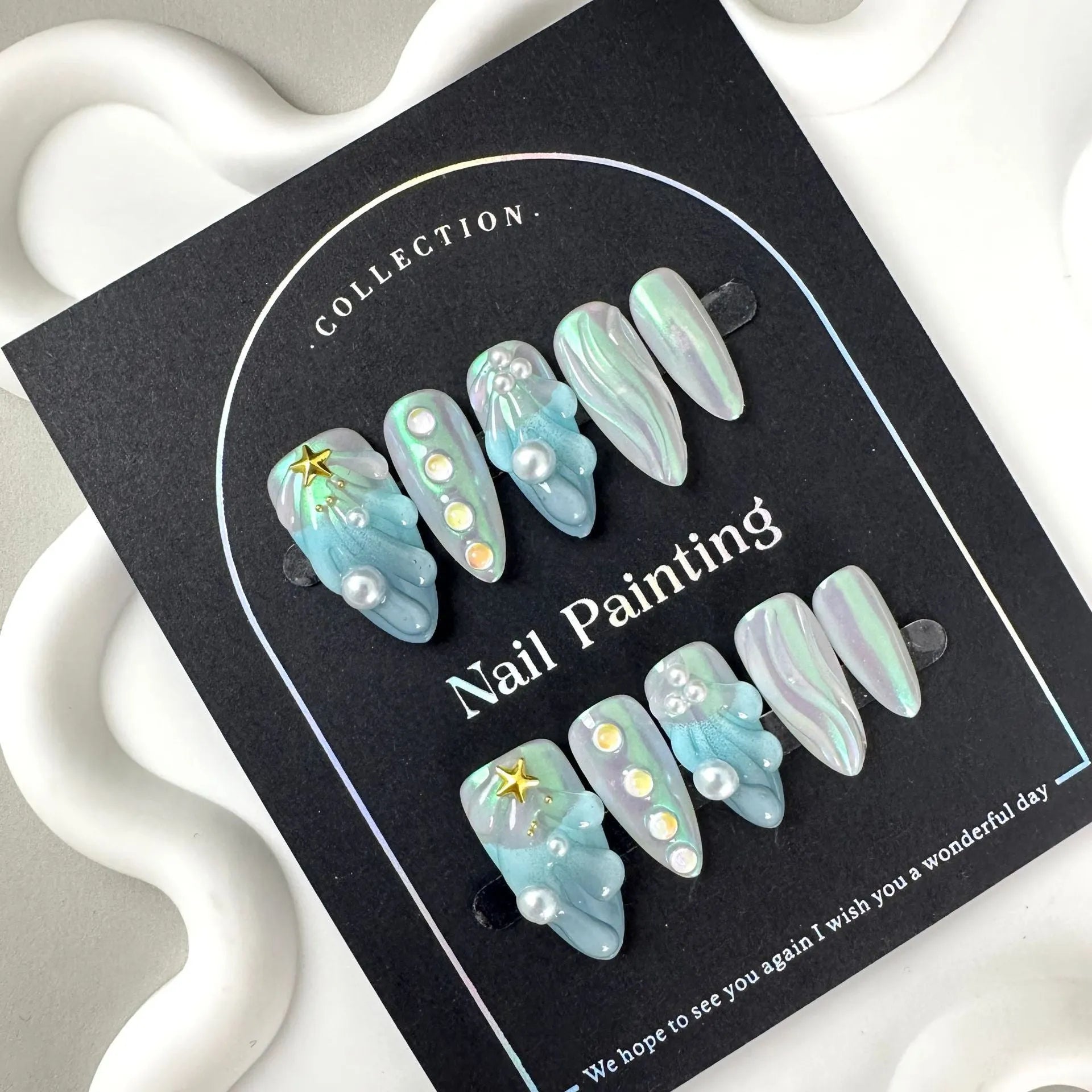 HAILANG blue plastic false nail tips set showing shell design with XS, S, M, L sizes.