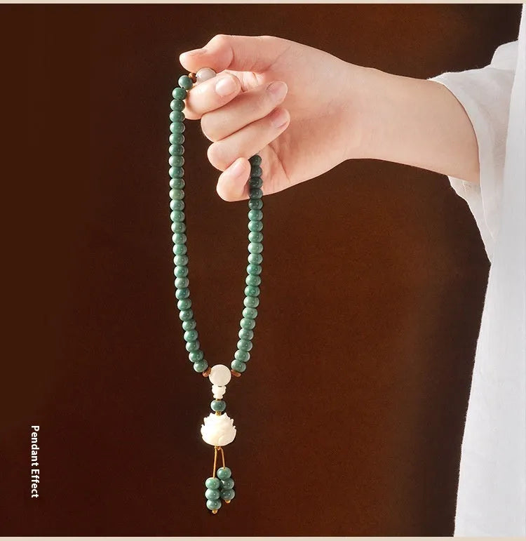 Unisex natural Bodhi seed bracelet with white jade beads and green sandalwood on a white background.