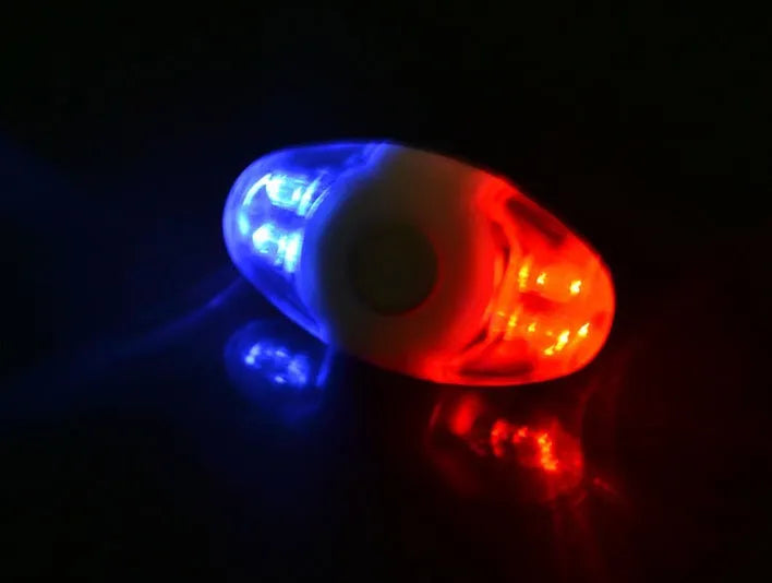 Red and blue LED bicycle tail light with adjustable mounting base shown in horizontal position.