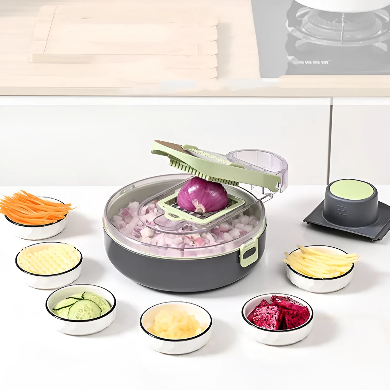 Grey and white multifunctional vegetable cutter set with eight stainless steel knives and accessories on a countertop.