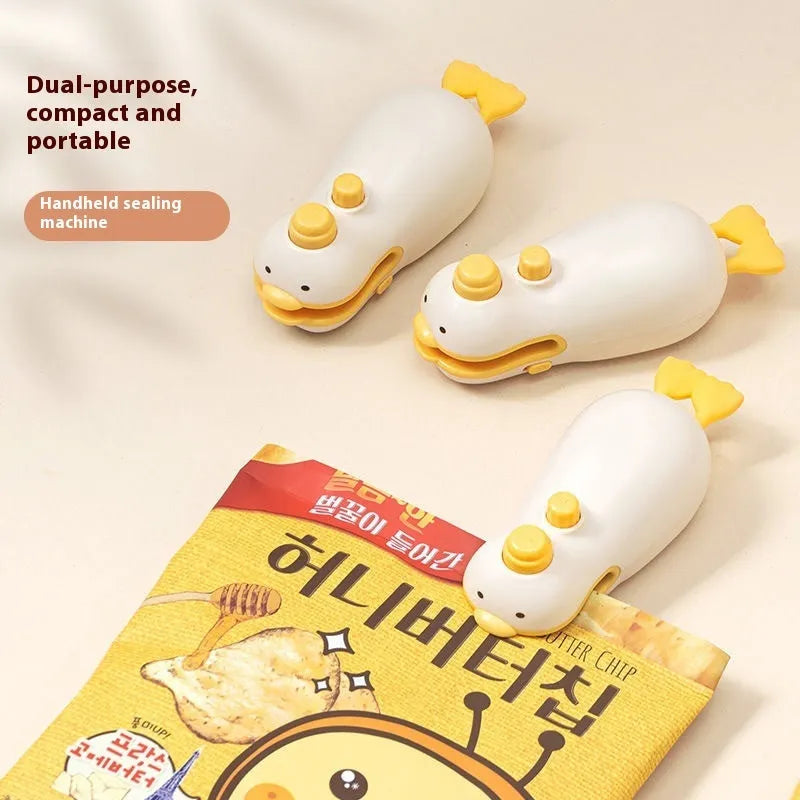 Small yellow duck animal jacquard design rechargeable handheld sealing machine with USB charging cable.