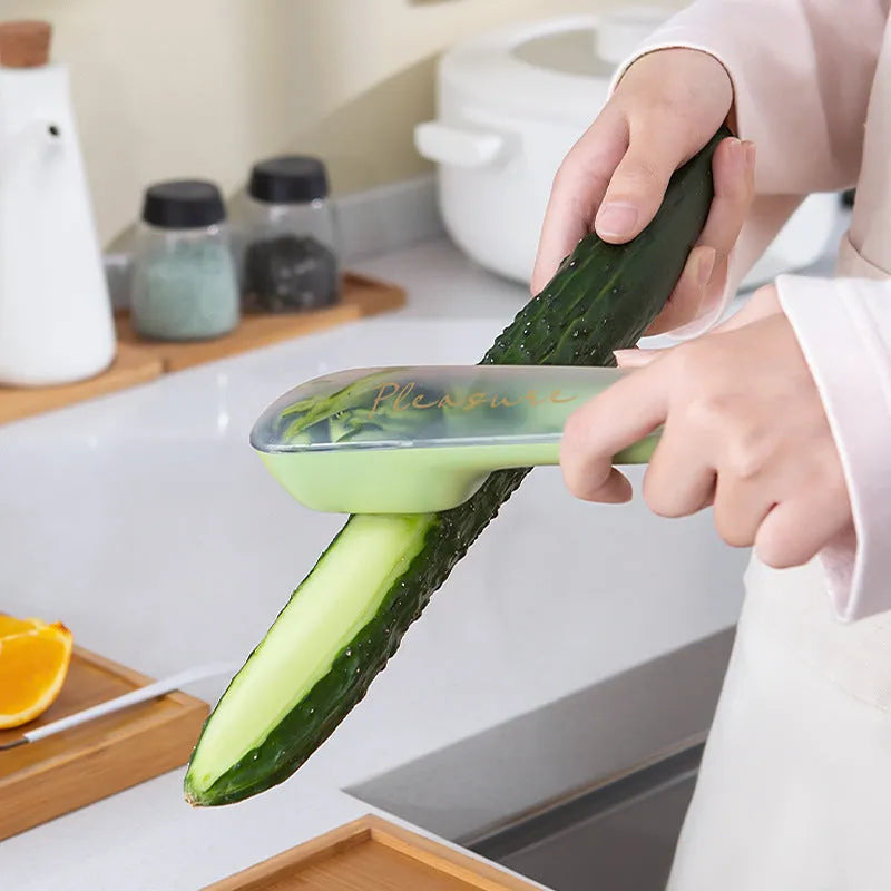 Green kitchen peeler with storage tube, stainless steel blade and hanging hole on handle