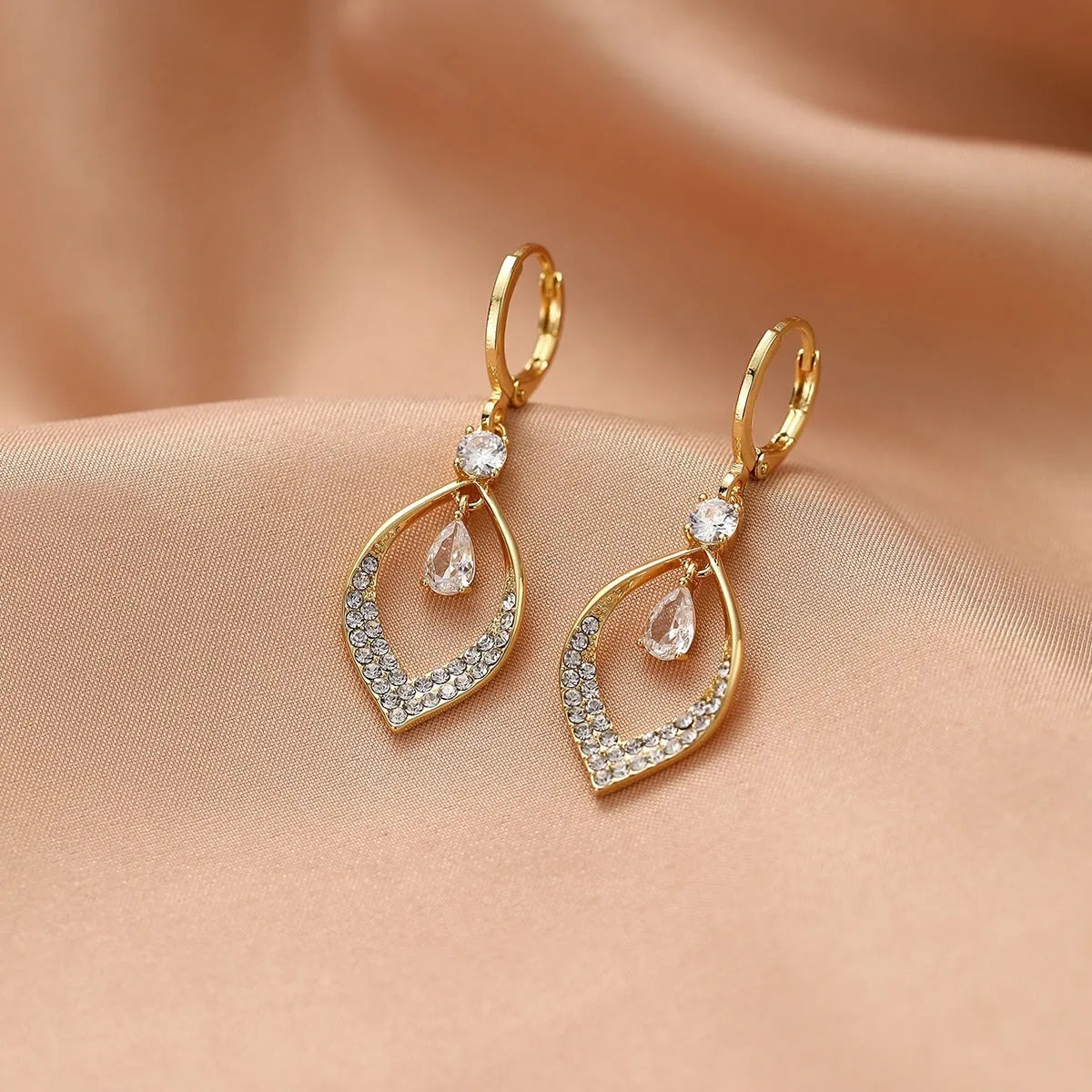 Gold and silver coloured zircon water drop tassel earrings with a tear-drop shape.
