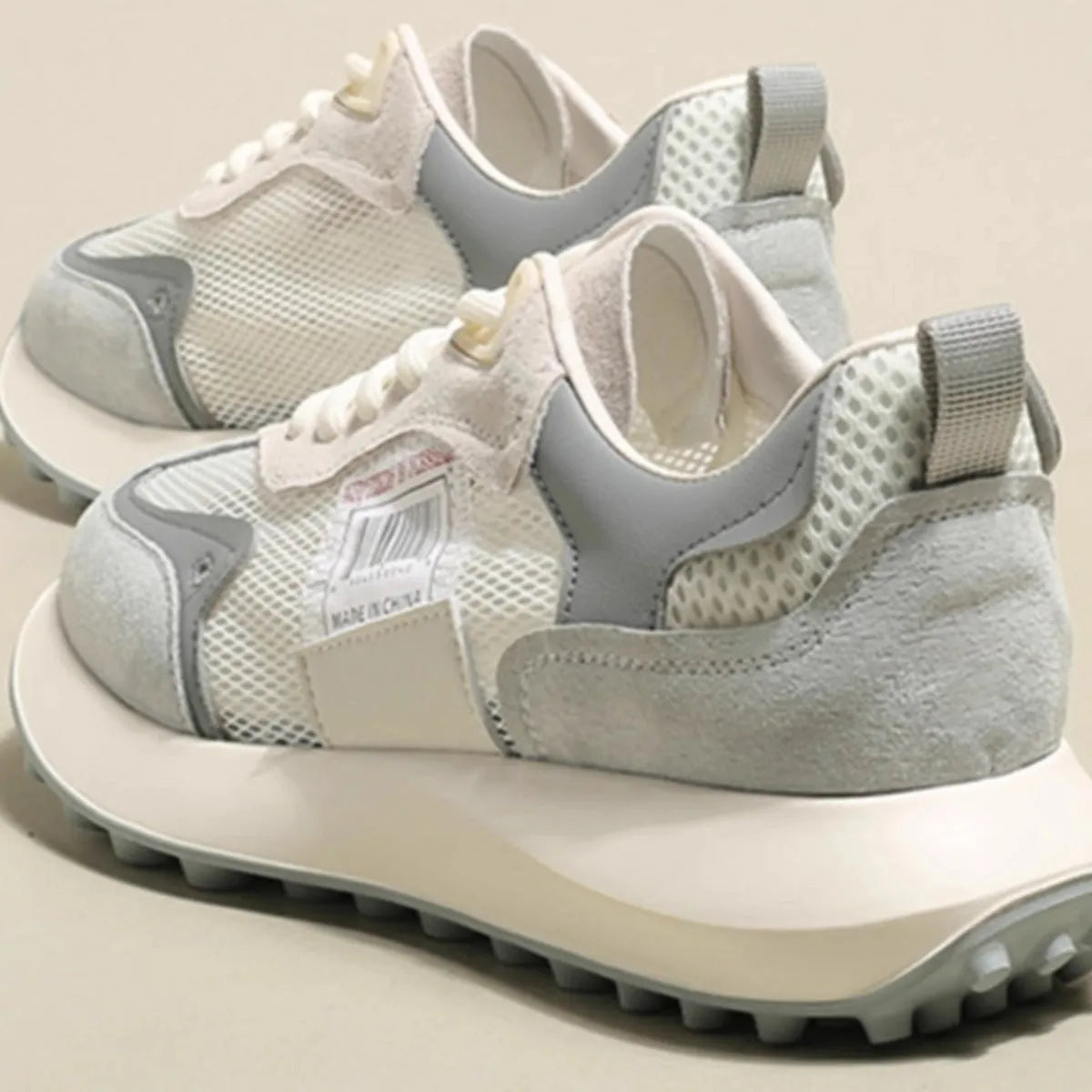Women's grey and pink low-top retro sneakers with round toe and flat rubber sole