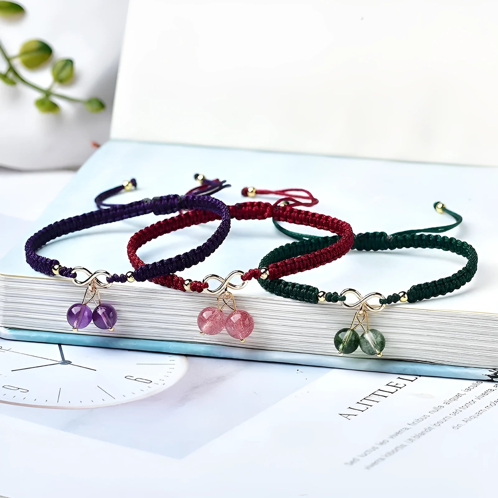 Women's natural strawberry quartz bracelet with a fruit-shaped crystal charm on wrist.