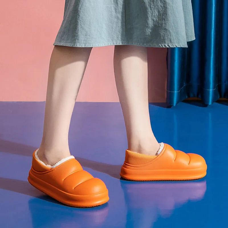 Women's green waterproof EVA winter slippers with plush lining and a non-slip sole.