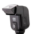 Silver top-mount SLR camera flash accessory with head tilted up, showing hot shoe mount and battery compartment.