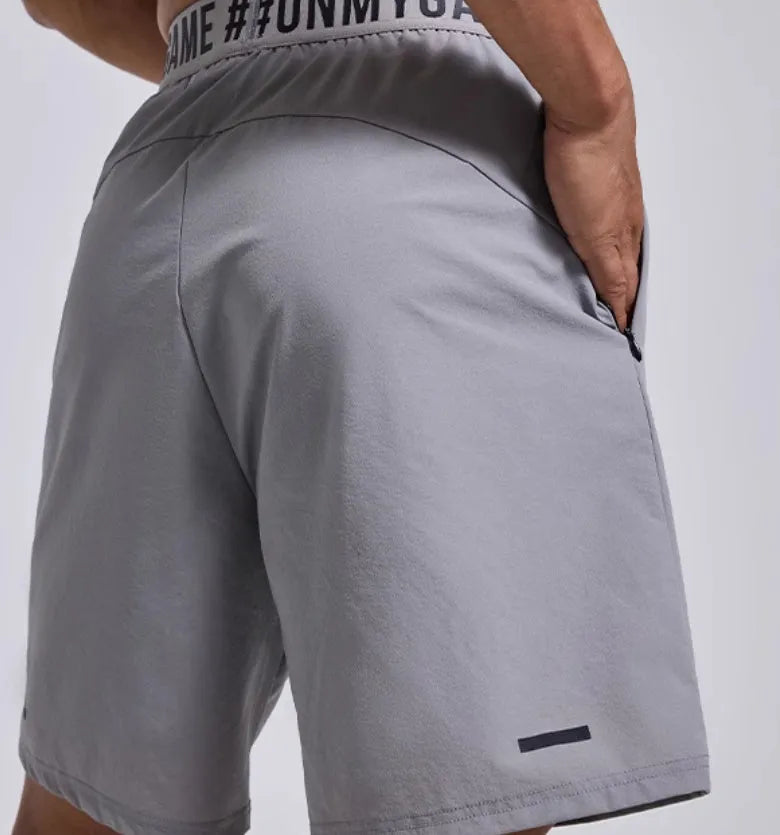 Men's loose grey athletic shorts with an elastic fly opening and letter print, shown from the front.
