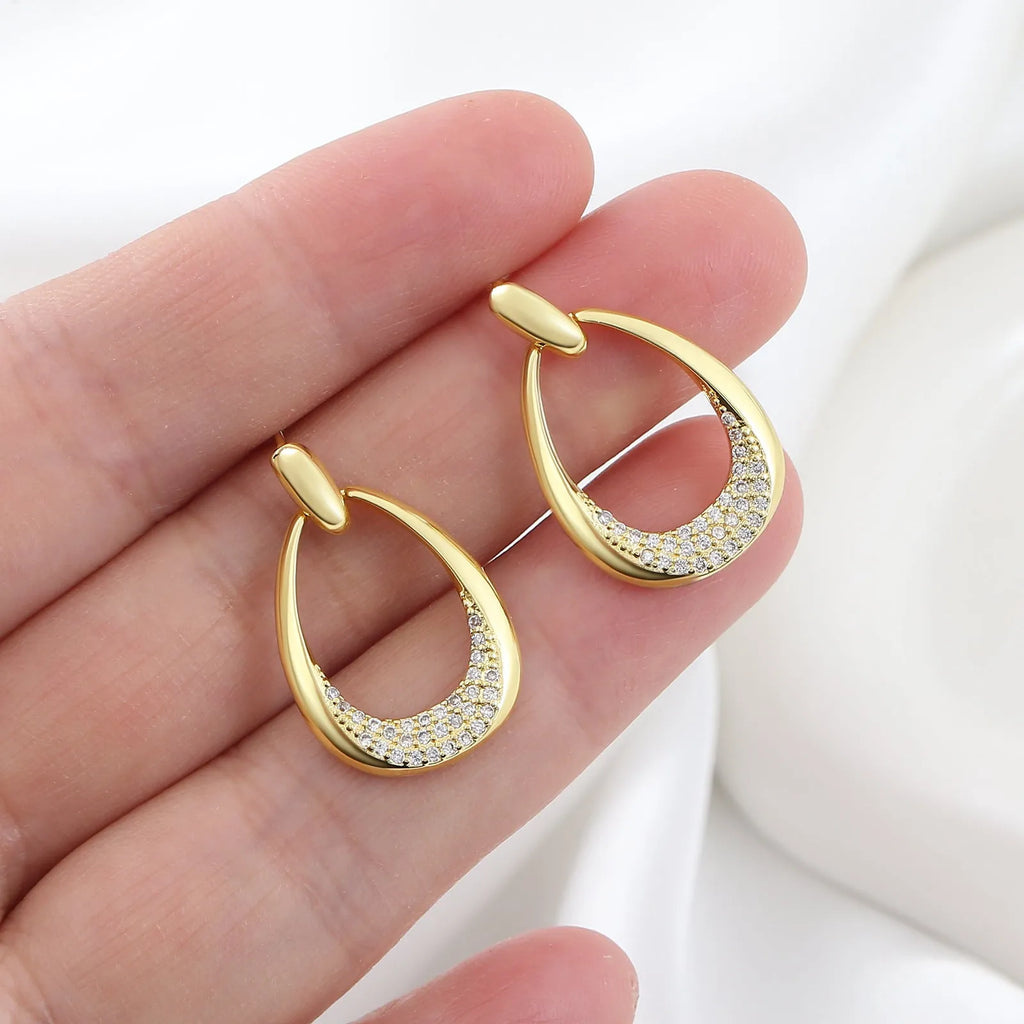 Yellow gold geometric drop earrings for women with a simple ring-style design.
