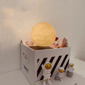 Maglev floating planet night light with LED glow, astronaut figurines, and USB cable.