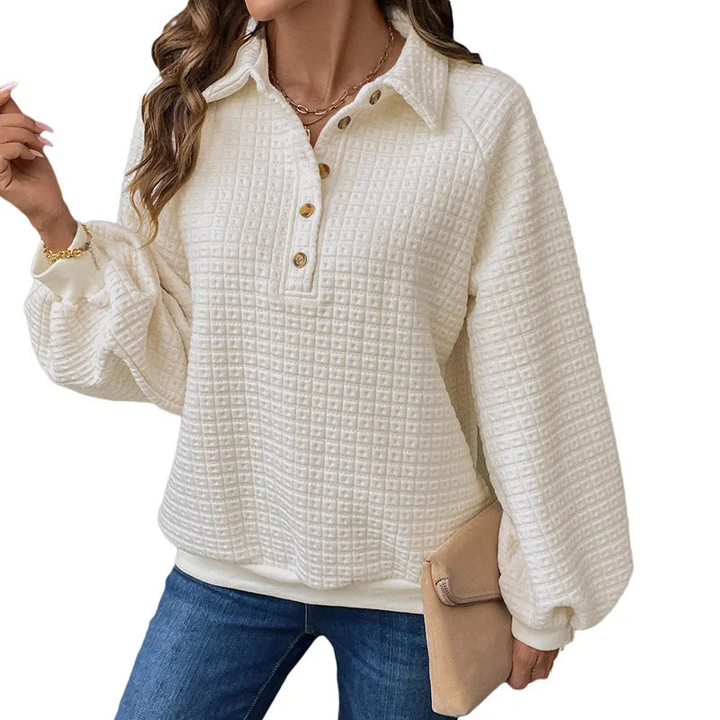 Women's beige textured polo collar long sleeve sweater laid flat.