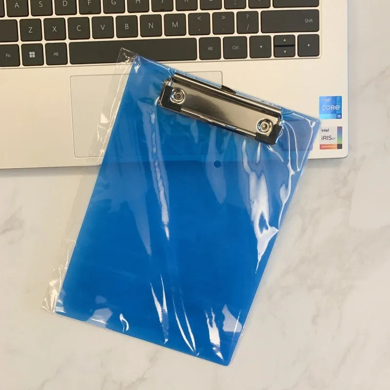 Transparent A4 writing board pad with metal clip holding paper, shown in blue colour variant.