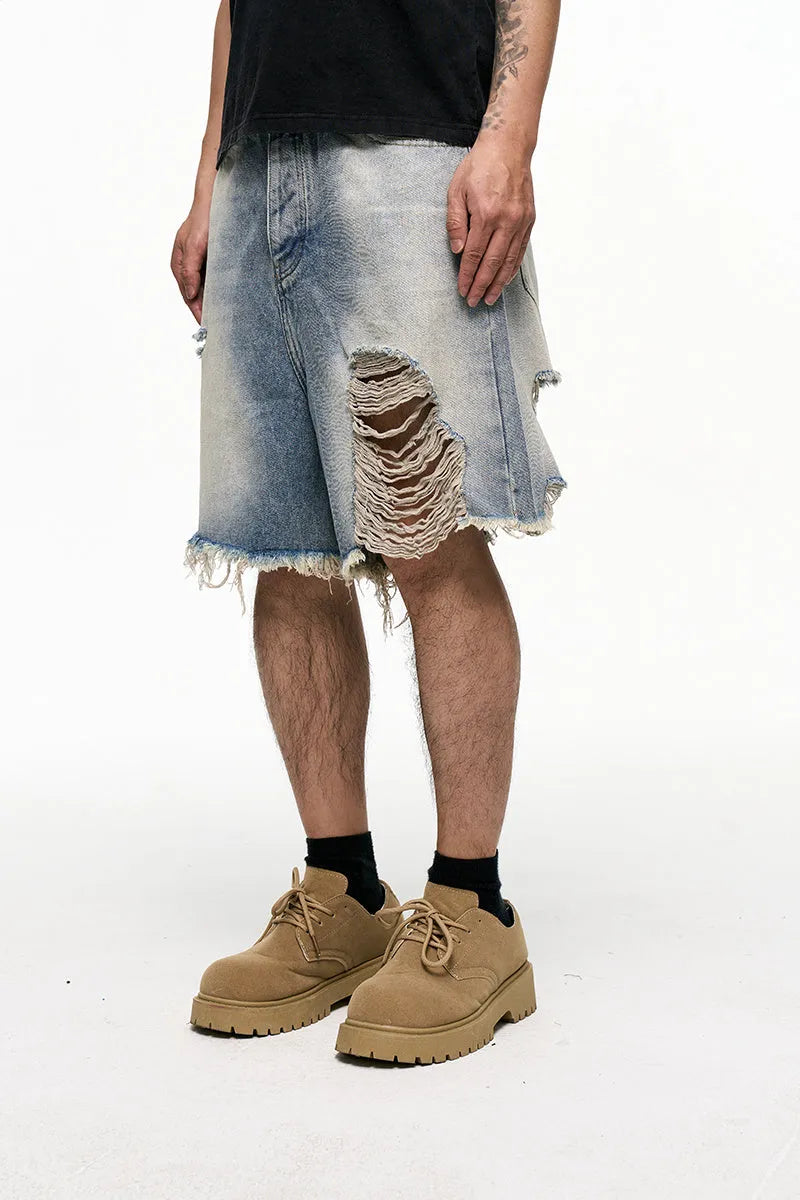Light blue men's baggy denim shorts with wide leg and mid waist on a plain background