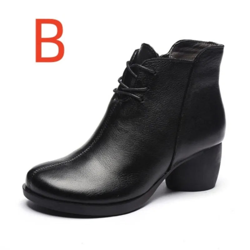 Women's black leather Martin boots with a thick middle heel and round toe on a white background.