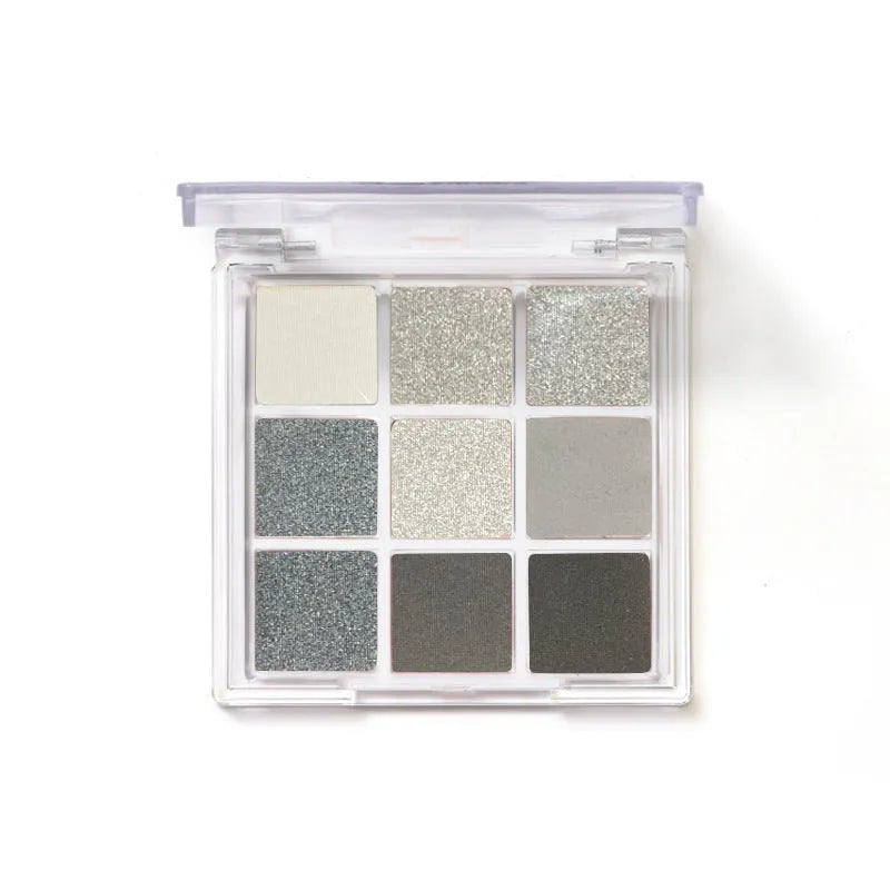 Smoked nine-colour eye shadow plate showing white, silver, black and iron grey pressed powder shades