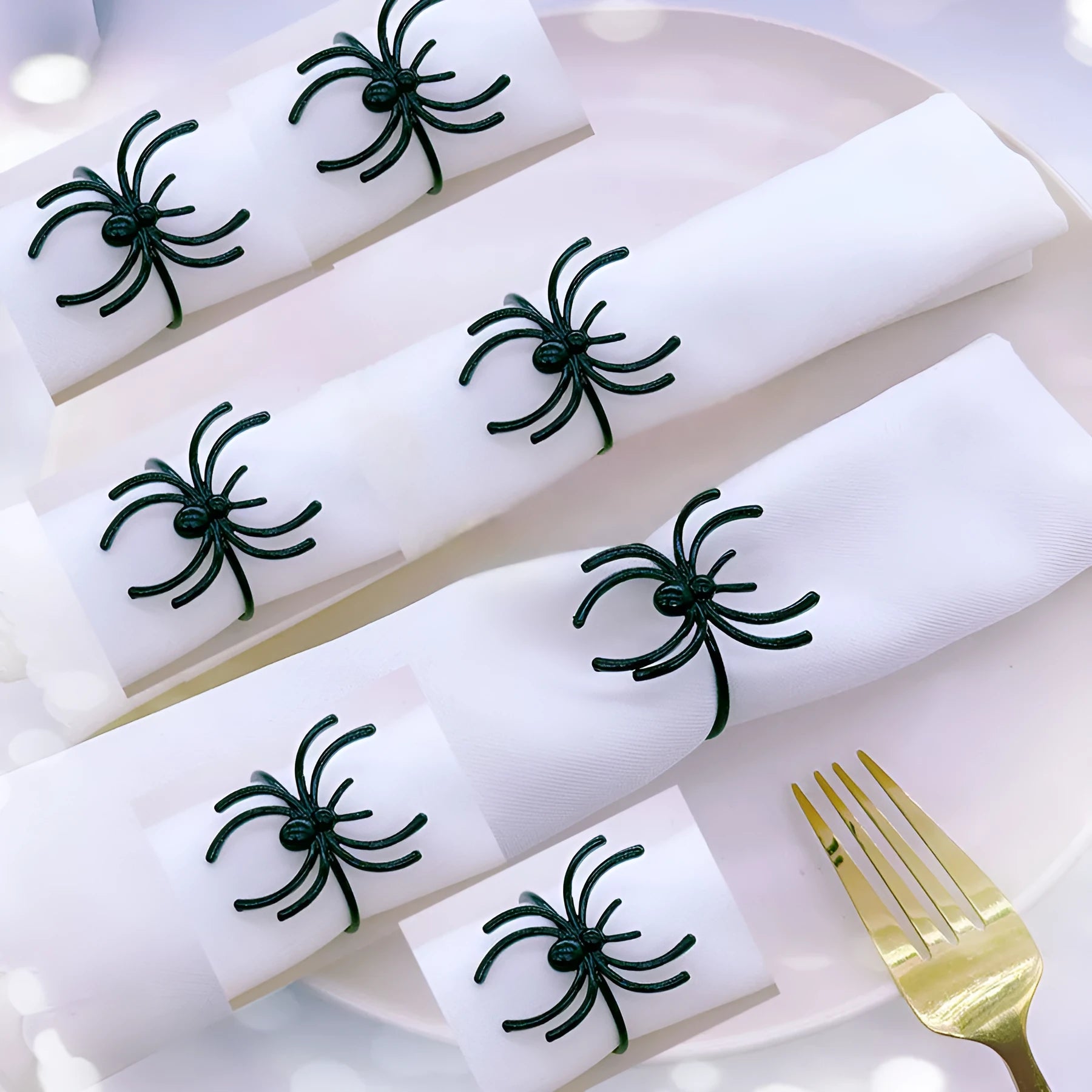 Set of six black alloy spider-shaped napkin rings for Halloween table decoration