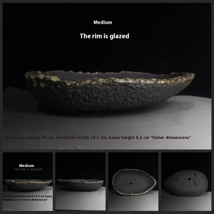 Handmade purple clay flower pot showing unique shape and traditional ceramic texture