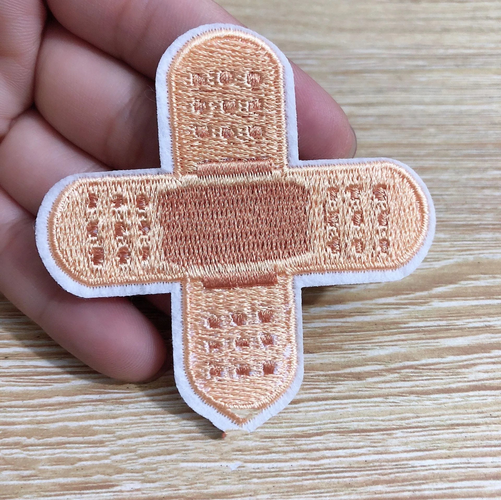 Ten embroidered cloth patches with lace edges for clothing decoration on fabric background