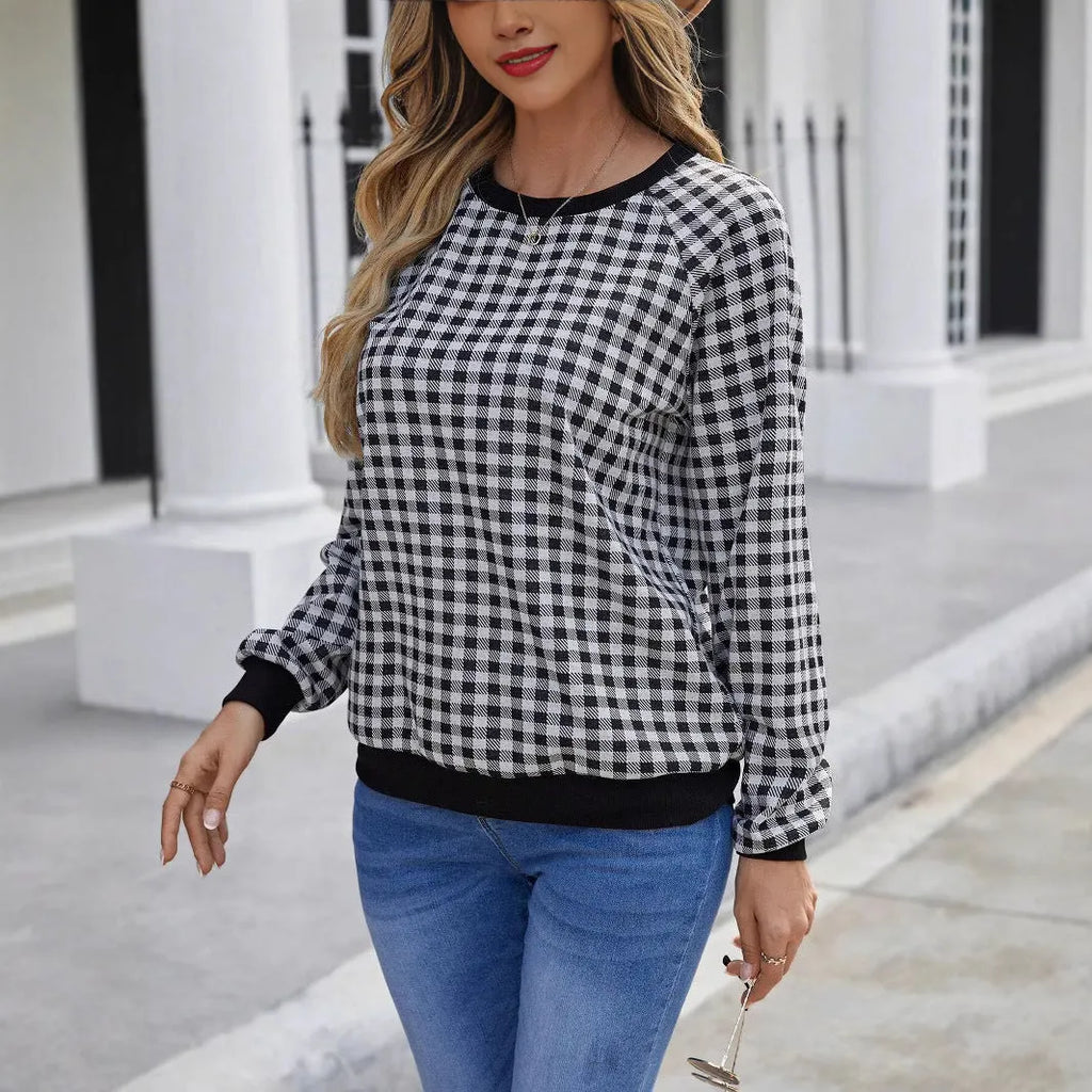 Black plaid and stripe pattern pullover sweater with long sleeves on mannequin