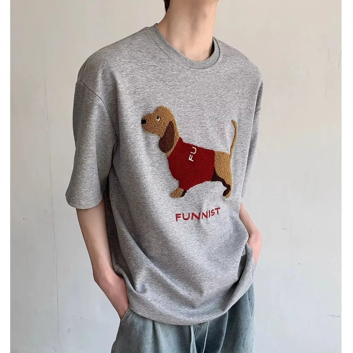 Men's grey cotton t-shirt with an embroidered black and white dachshund dog design on the chest.