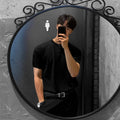 Men's slim-fit ice silk short-sleeved shirt in black, laid flat showing knitted texture and collar.