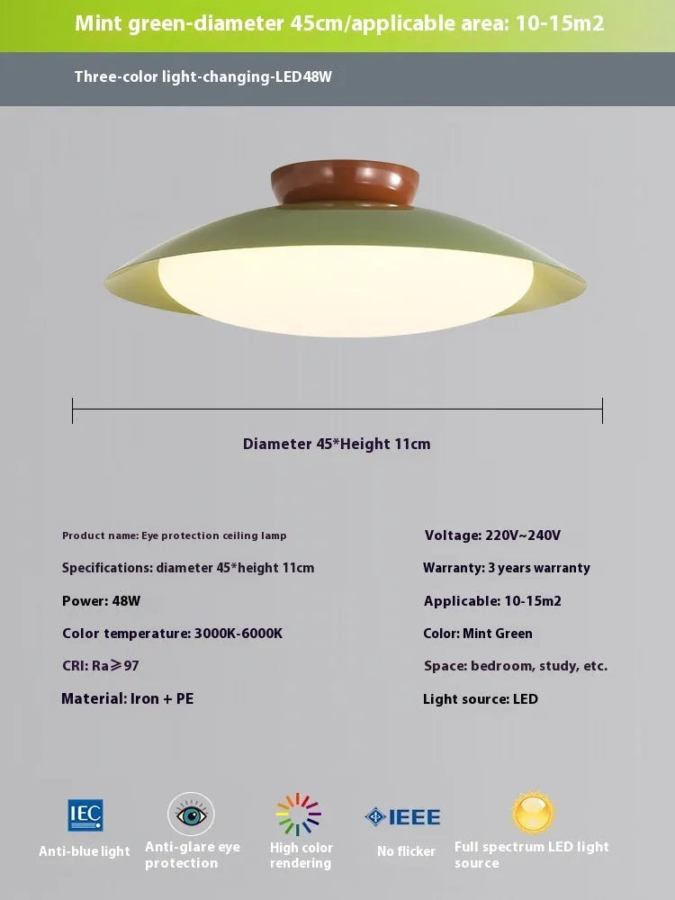 Modern cream-style flying saucer shaped ceiling lamp in a bedroom setting.