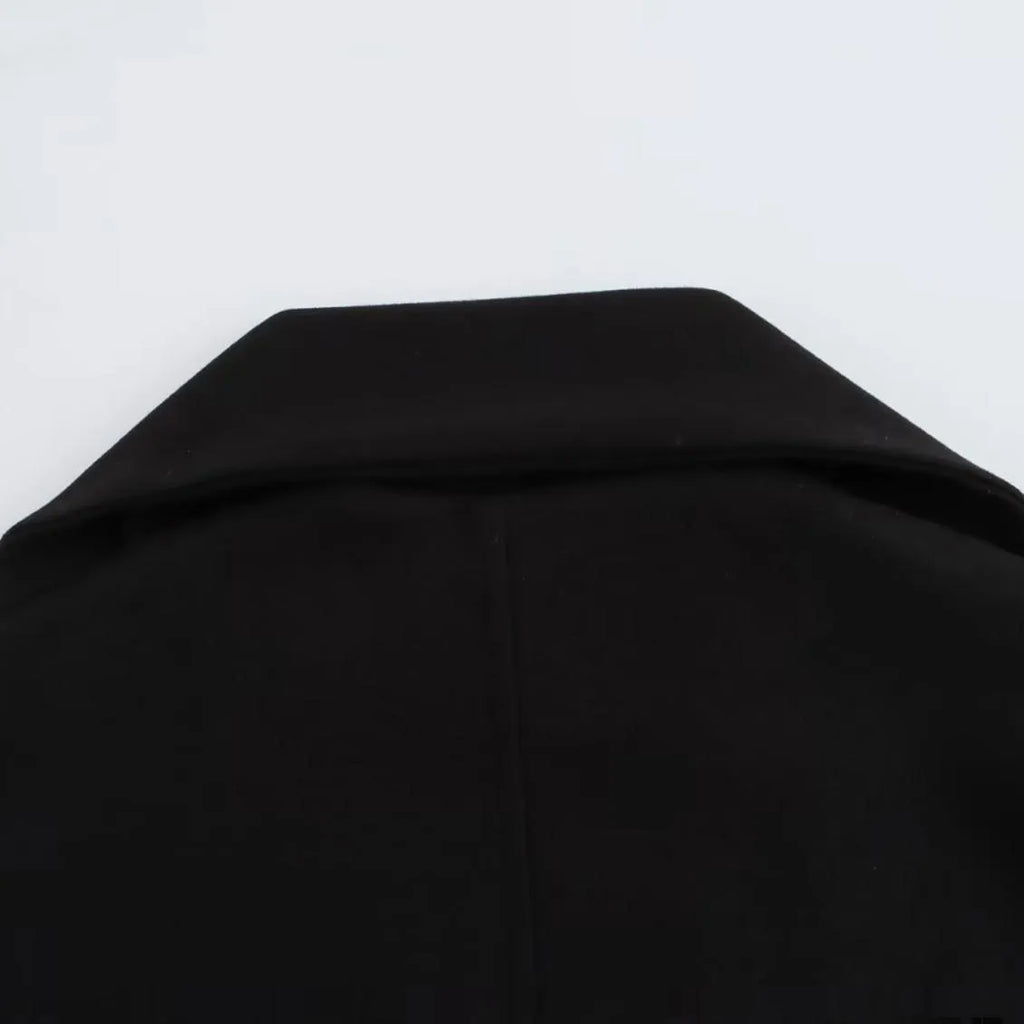 Women's long black polyester overcoat with artificial fur collar, shown at full length.