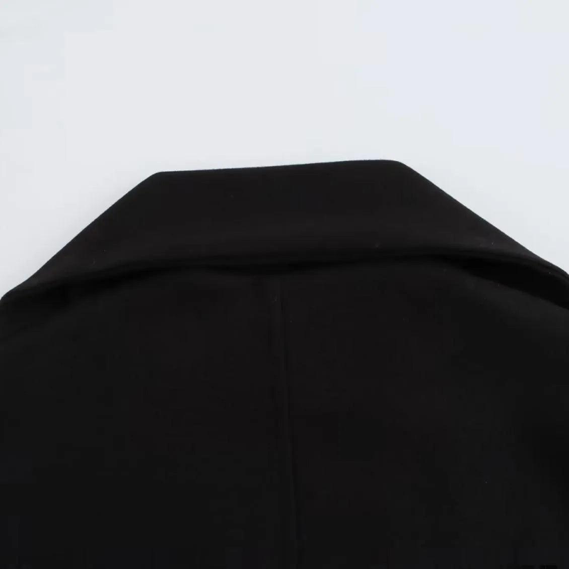 Women's long black polyester overcoat with artificial fur collar, shown at full length.