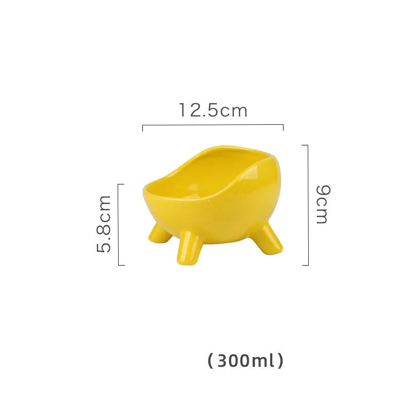 Green ceramic pet food bowl with four-legged base and rounded arc design