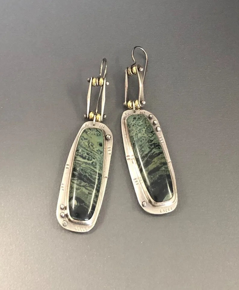 Geometric alloy earrings with black and white marble pattern showing front and side views