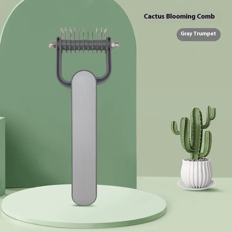 Green and grey dog hair unknotting comb with stainless steel teeth on a plastic handle.