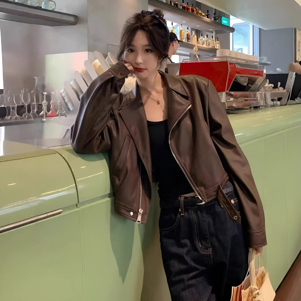 Women's slim-fit short brown retro leather jacket with long sleeves and a pocket.