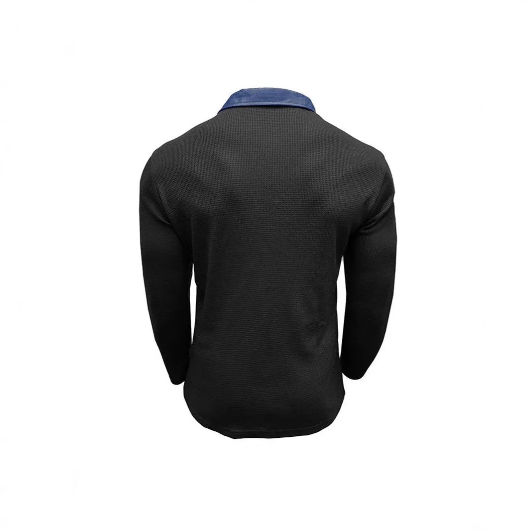 Man wearing a long-sleeve waffle-texture polo shirt in a loose retro fit, showing asymmetric design detail.